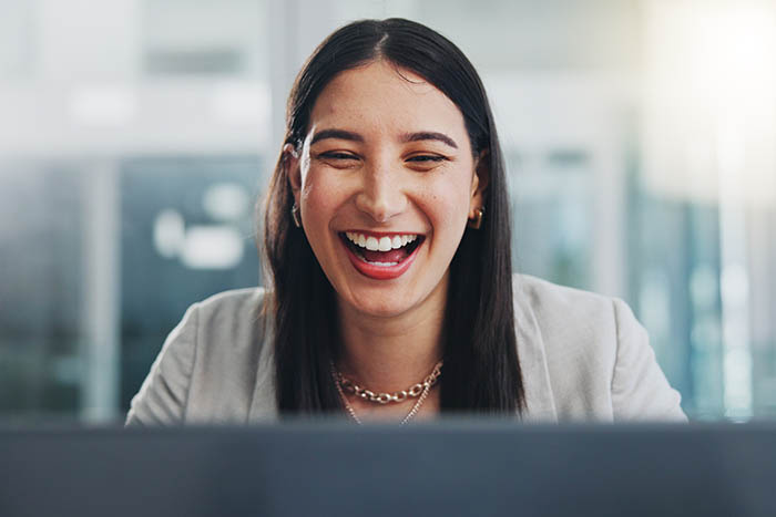 Business Woman Smiling Looking at Laptop