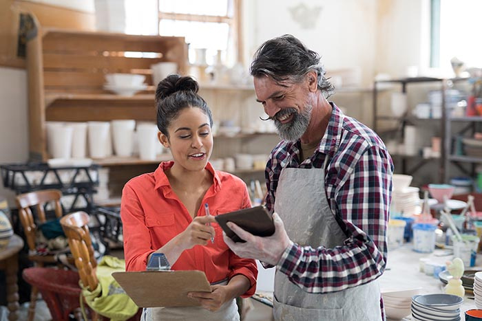 People working at a pottery business