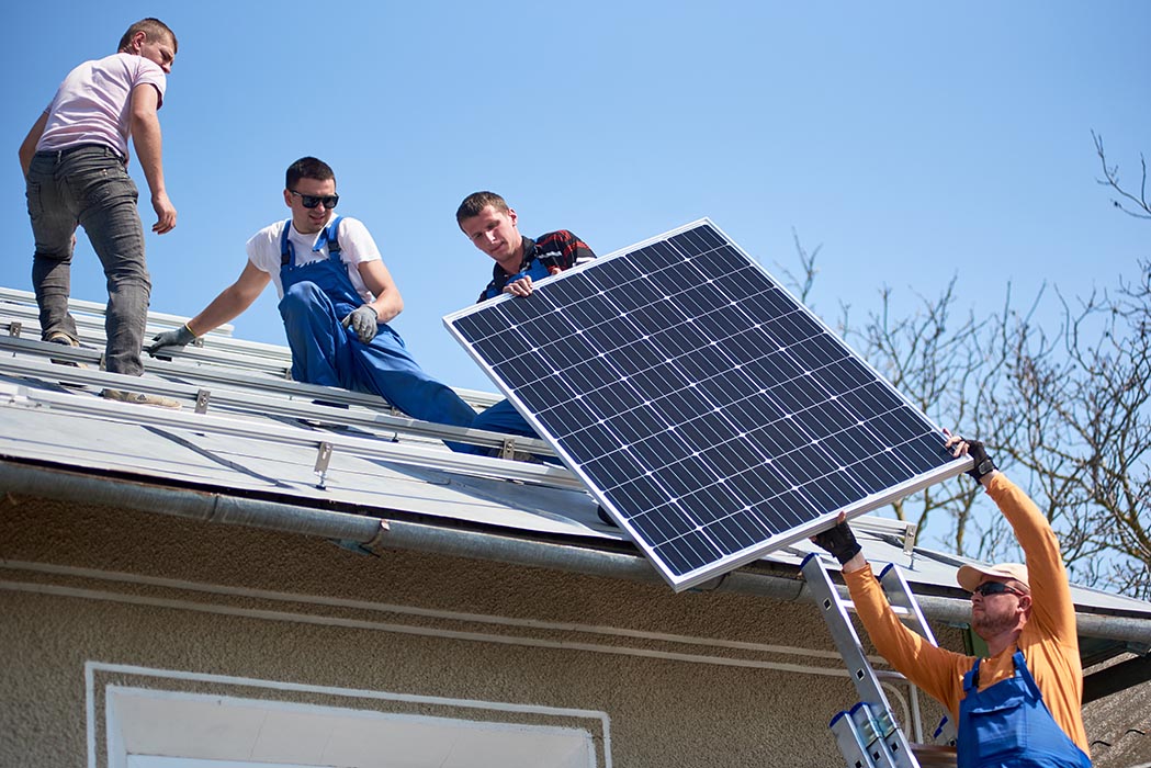 Installing solar panels on the roof of a home