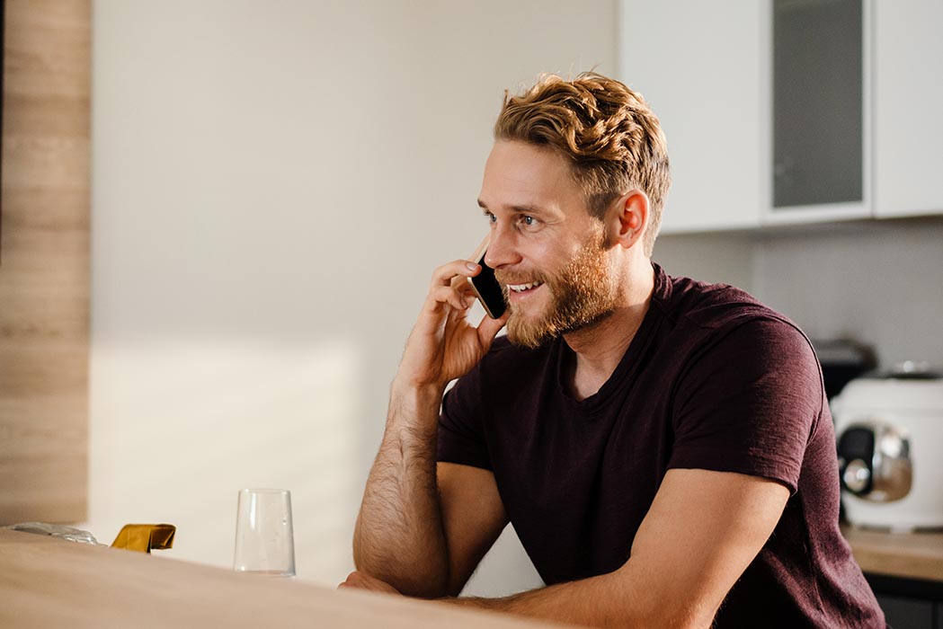 Person Using their Mobile Phone from Kitchen