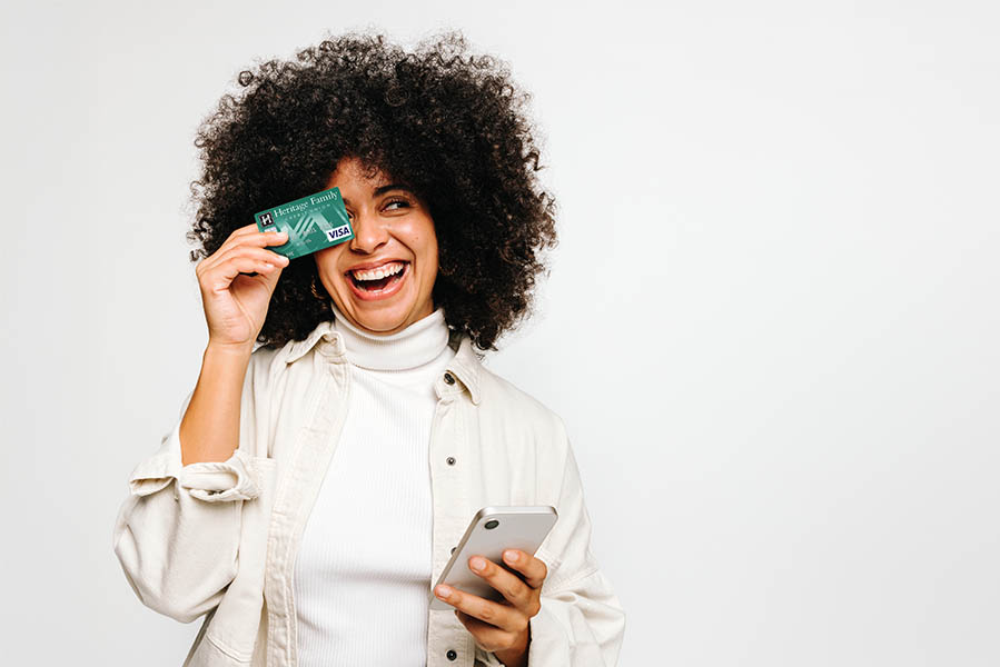 Woman holding a credit card and smartphone
